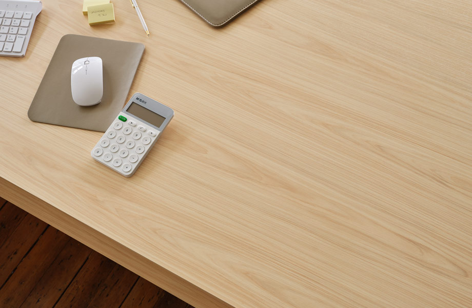 Calculator, keyboard and computer mouse on desk with Natural Refined Hickory Formica Laminate surface